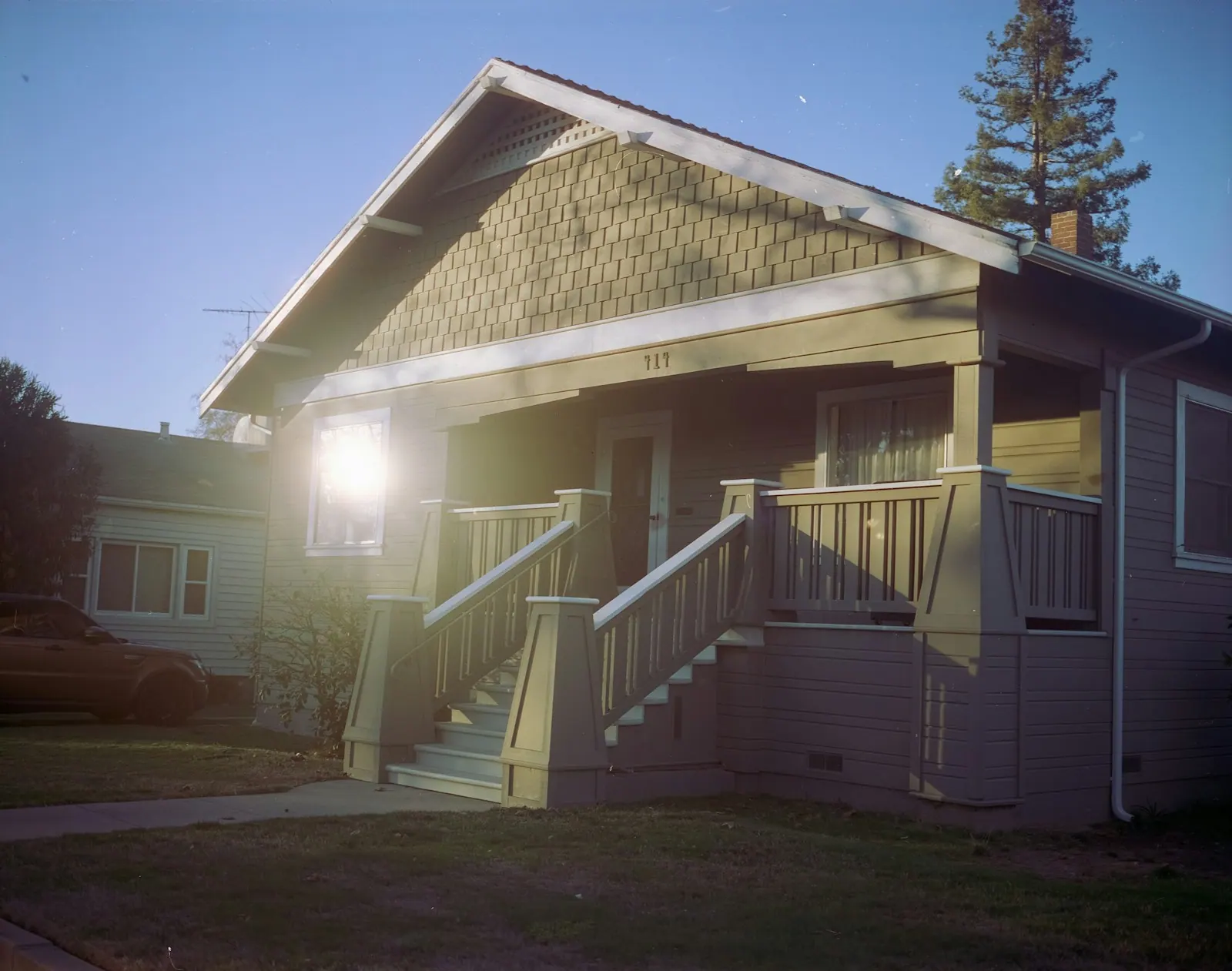 White craftsman wooden house near green trees in Tustin California